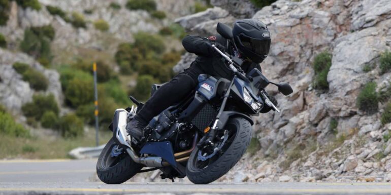 Honda CB750 Hornet E-Clutch σε στροφή σε ορεινό δρόμο, με αναβάτη με μαύρο εξοπλισμό